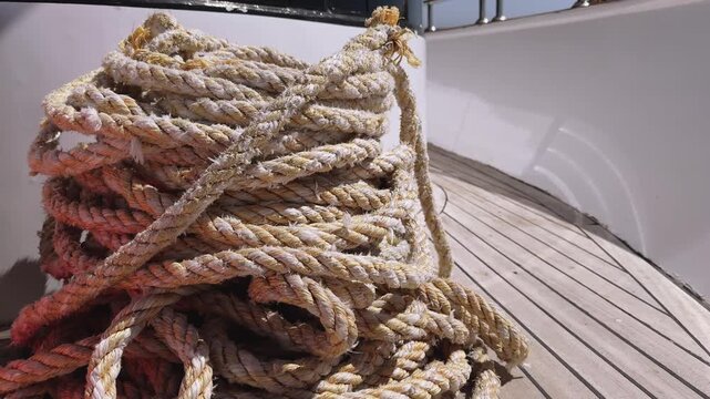 Close up of Mooring ropes and yacht deck prepared for anchoring in the sea