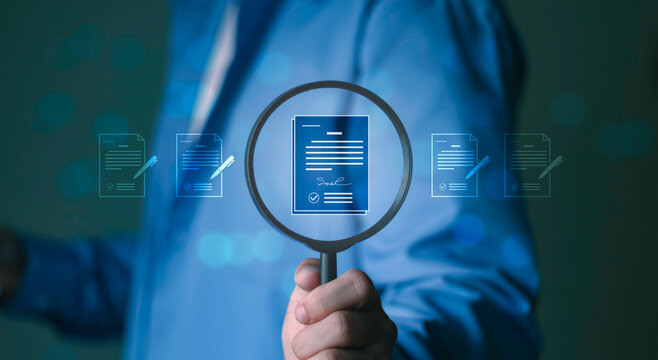Audit, document verification, compliance review, and quality control process. Business professional holding magnifying glass focusing on digital document with signature and checkmark icons.