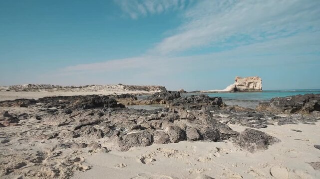 the sandy shore of a rocky Mediterranean bay where the summer sky meets the tranquil ocean waves in a beautiful travel landscape on cleopatra beach matrouh egypt
