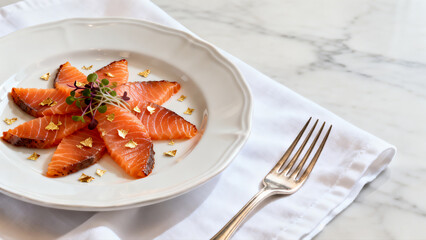 Elegant Salmon Carpaccio With Edible Gold Leaf And Fresh Sprouts