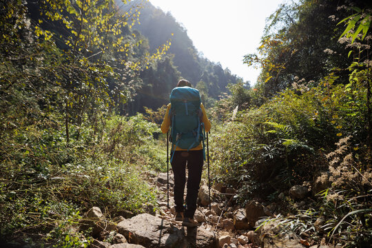 Successful backpacker hking in the mountains