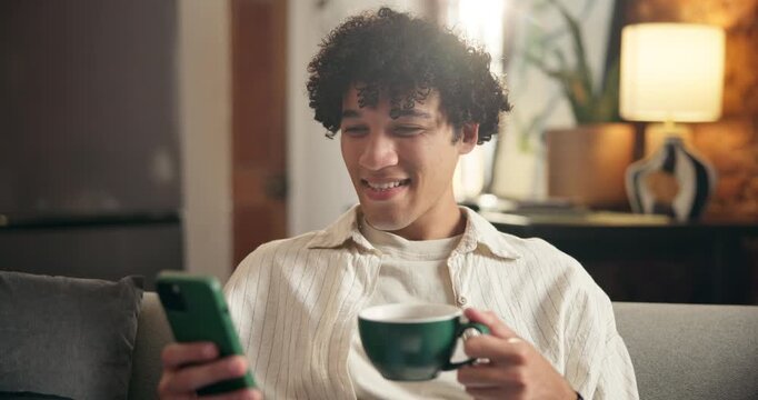 Home, coffee and happy man on sofa, smartphone for social media and message to contact. Apartment, espresso and person on couch, relax and cellphone for online reading and website for entertainment