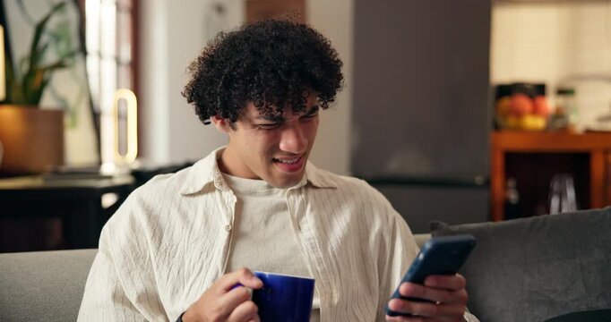 Shocked, coffee and man with phone on sofa, news article and negative social media trend for confusion. Upset, headline surprise or person with tea cup in home, mobile app and click bait video intro