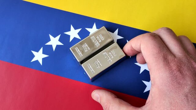 A silver bar, white metal against a flag of venezuela, as a concept for the sales market. A silver bar as a background for your design
