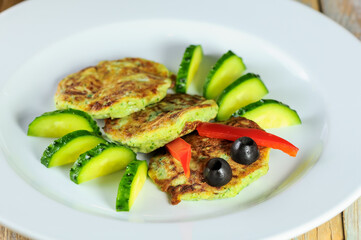 Savory Zucchini Fritters with Fresh Cucumber and Olive Garnish