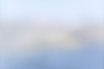 A pale blue frosted glass background that transmits soft light