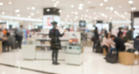 Fototapeta premium Blurred Modern Departmental Store Interior Seen with People Through Glass Wall 