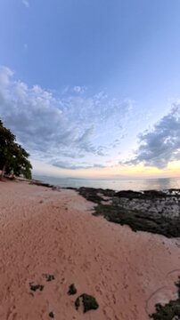 PATTAYA, THAILAND - NOVEMBER 2025 : View of Jomtien beach and beautiful sunset sky. Travel and tourism concept video. Vertical shot.