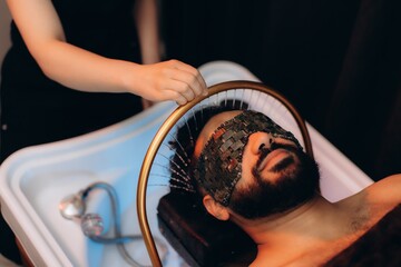Man receiving head spa treatment for relaxation and wellness. Japanese spa head © Roman