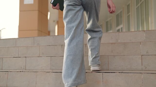 girl goes to school climbing steps, child goes to class holding book hand, educational program, child kid first grader holding book hands runs class, child goes school, child school backpack goes