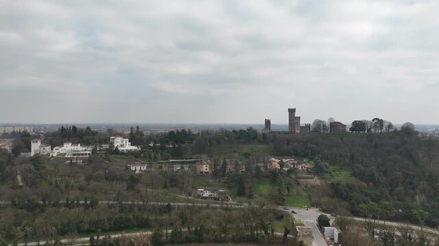 Valeggio sul Mincio with the Visconti Bridge and Borghetto riverside hamlet, showing the Mincio River, weir, historic mills and hillside towers above the town in Veneto, northern Italy
