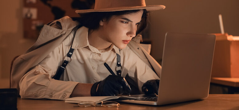 Female spy with laptop writing on notebook in office at night