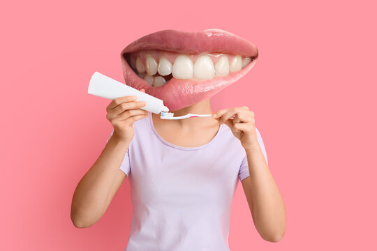 Young woman applying tooth paste onto brush on pink background
