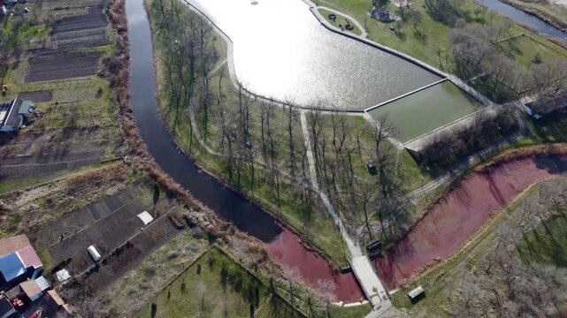 Aerial drone view of Kikinda park with lake and canals, residential neighborhood and fields, Serbia.Staro Jezero, Kikinda, Europe. g.