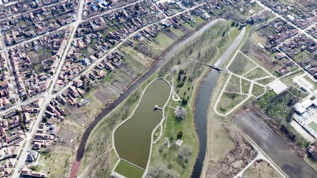 Aerial drone view of Kikinda park with lake and canals, residential neighborhood and fields, Serbia.Staro Jezero, Kikinda, Europe. g.