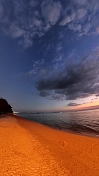 PATTAYA, THAILAND - NOVEMBER 2025 : View of Jomtien beach and beautiful sunset sky. Travel and tourism concept video. Vertical time lapse shot.