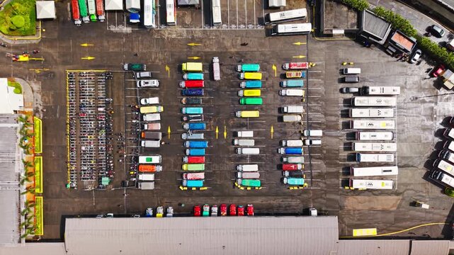 Vertical drone lowering over vibrant Filipino jeepneys at sunrise, top down view