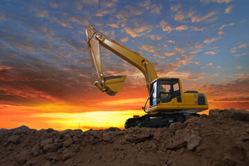 Crawler excavators  are digging the soil in the construction site. With  sky and clouds of on sunset background © chaphot