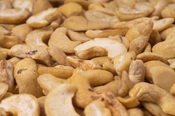 Fototapeta premium Cashew nuts close-up as texture, background, pattern. Selective focus, front and rear blurred
