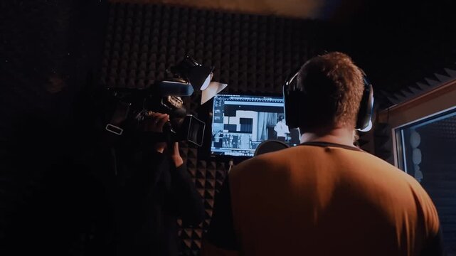 Professional voice actor recording audio book or podcast, portrait with microphone in recording studio, man creating audio advertising for radio or online sites, dubbing and dubbing in video productio