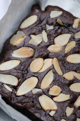 Authentic homemade chocolate brownies topped with crunchy sliced almonds