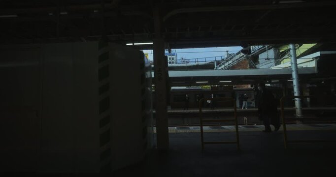 View through Japanese train window as it leaves station