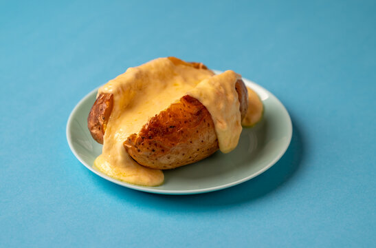 Baked potato with an abundance of melted raclette cheese