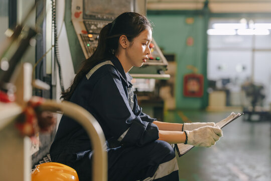 Woman worker sitting reading study job detail document feel worry stressed in industry factory