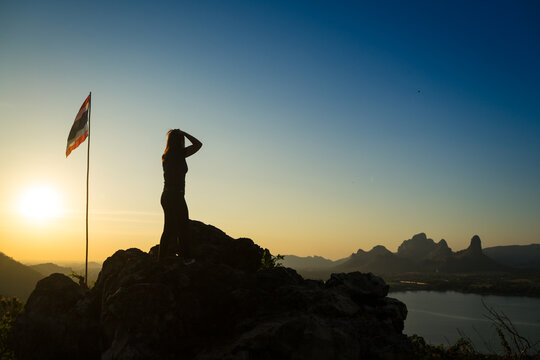 Hiker to hiking to spectacular viewpoint  that overlooks Sub Lek reservoir, hence the name. Quite a strenuous hike is required at Lopburi Province, Thailand. View of mountain and lake on sunset.