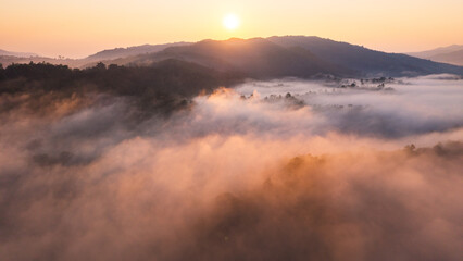 Aerial view of beautiful sunrise over the sea of mist in the mountains.