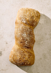 Rustic artisan bread loaf on light background, top view