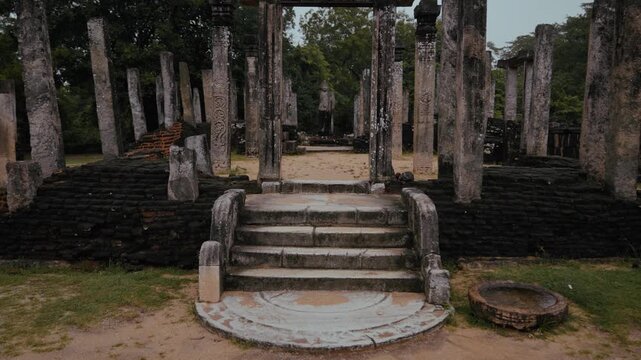 Stone staircase with moonstone carvings leading to Buddha statue at Vatadage temple in Polonnaruwa, Sri Lanka