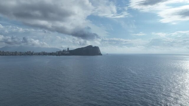 Aerial approaches haunting image of Benidorm headlands as clouds mass Spain
