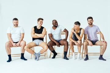 Obraz premium group of multiethnic men posing for a male edition body positive beauty set. Shirtless guys with different age, and body wearing boxers underwear