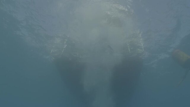 log footage of scuba divers jump to the sea from boat underwater shot