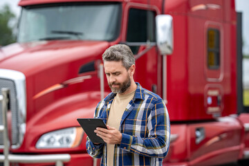 Man owner truck driver. Transportation logistic. Delivery app. Logistics software. Man driver use tablet at lorry truck. Tracking delivery. Truck driver. Trucking owner planning route © be free