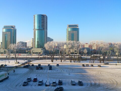 Winter view of the Titan business center skyscrapers and frosted trees on Dzerzhinsky avenue in Minsk, Belarus, 2014 