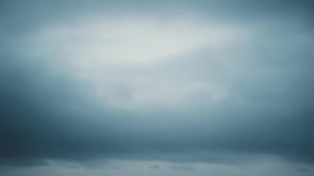 Dark storm clouds roll over a vast, moody ocean, restless deep blue waves approach the shore under an overcast, dramatic sky, evoking solitude and raw nature