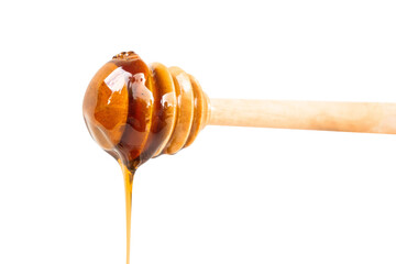 close-up of honey dripping from a wooden dipper
