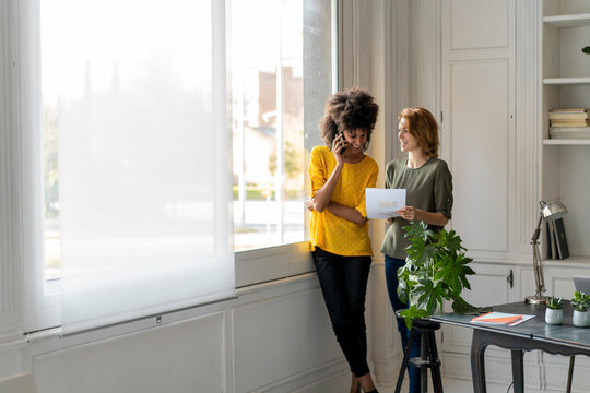Colleagues in coworking space discussing business solutions