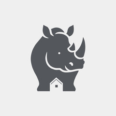 Obraz premium Rhinoceros with House Silhouette Negative Space Logo