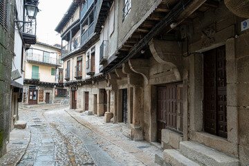 Fototapeta premium Narrow street with traditional stone buildings.. La Alberca, in the province of Salamanca, Spain