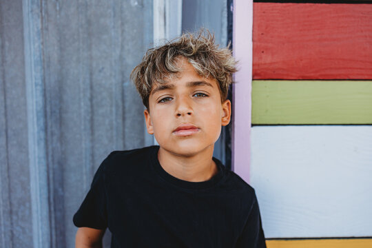 Boy with highlights in his hair looking at the camera.