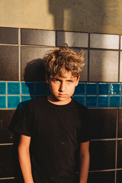 Sun hitting boys' hazel eyes who is looking at camera.