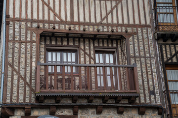 Obraz premium Wooden balcony with windows on a stone wall.. La Alberca, in the province of Salamanca, Spain