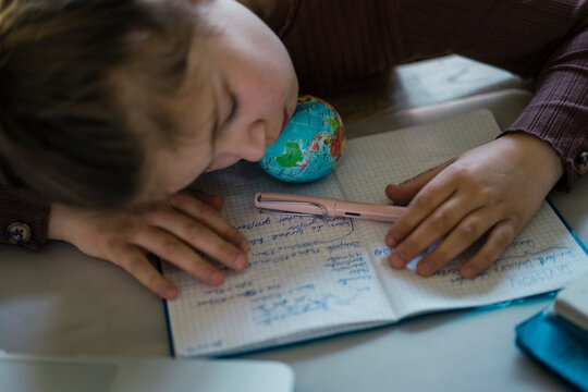 Girl napping while studying on table