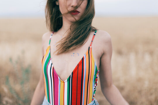 Woman wearing swimsuit standing in field