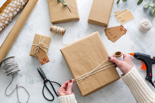 Hands of woman wrapping Christmas presents