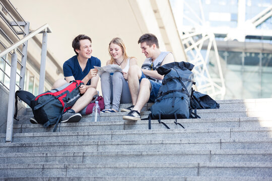 Young people exploring Berlin, looking at map