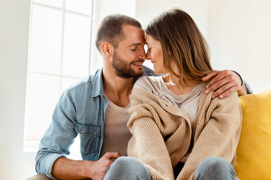 Affectionate smiling couple with closed eyes in love at home
